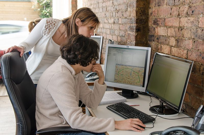 2 women studying a computer