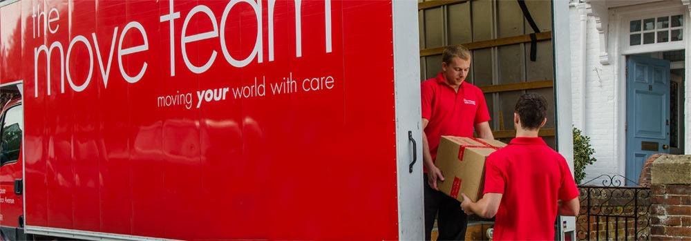 move team staff unloading a box from a van