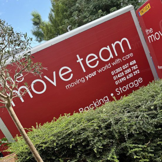 move team vans in front of a hedge