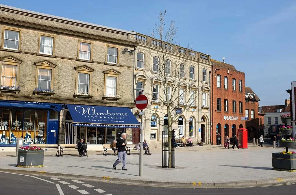 Scenic view of the historic Wimborne Minster town centre street in Dorset, illustrating a guide for moving to Wimborne