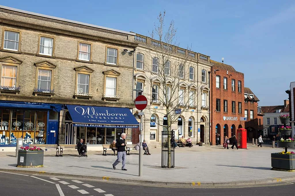 Scenic view of the historic Wimborne Minster town centre street in Dorset, illustrating a guide for moving to Wimborne